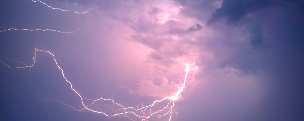 Capture the power of nature with this striking lightning bolt against a dramatic stormy sky.