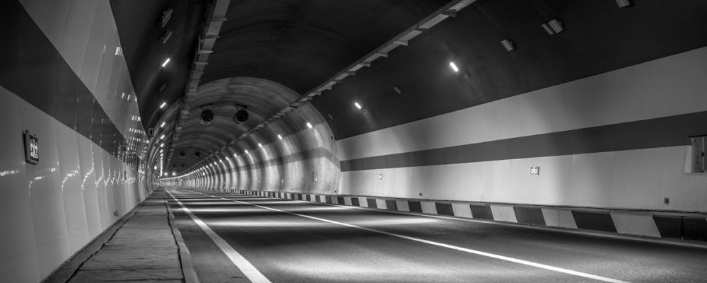 Monochrome image of a road tunnel showcasing depth and vanishing point.