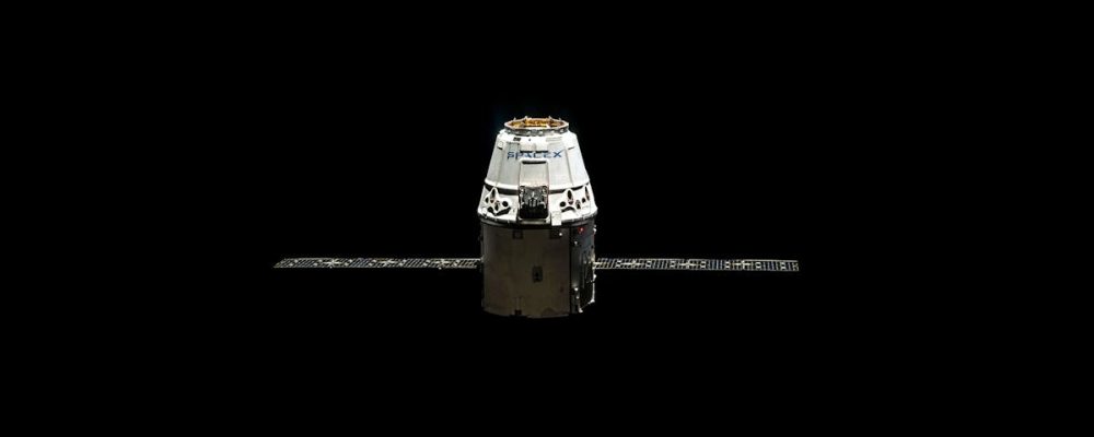 A SpaceX Dragon capsule orbited against the dark vastness of outer space.