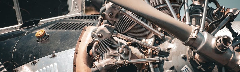 Detailed view of a vintage aircraft engine and propeller showcasing intricate mechanical design.