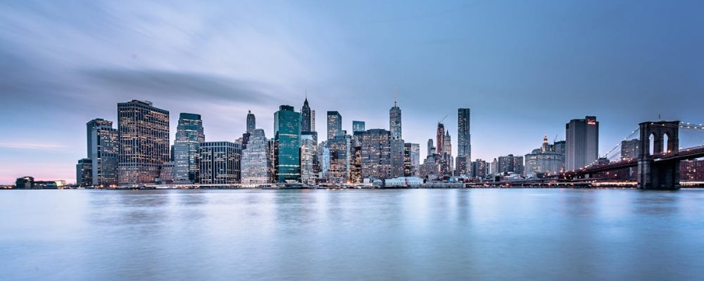 Stunning view of the New York City skyline and Brooklyn Bridge at dusk.