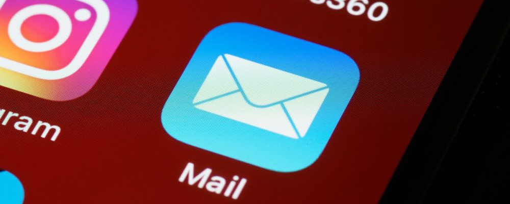 Macro shot of smartphone screen displaying various app icons including Mail and Instagram.
