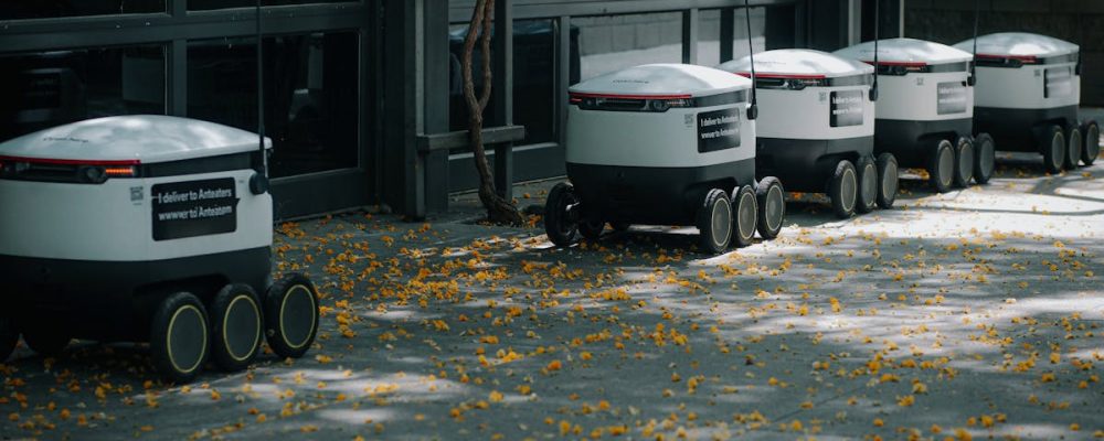 Autonomous delivery robots lined up outdoors showcasing modern transportation technology innovations.