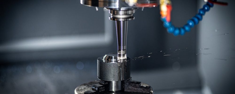 Close-up of CNC machine in action, showcasing precision engineering and industrial equipment.